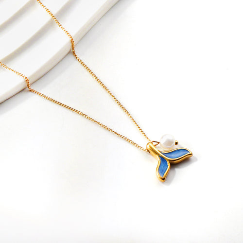 Gold necklace with a blue pendant on a white background