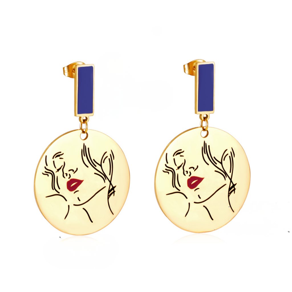 18k Gold earrings with face design and blue accents on a white background elazo
