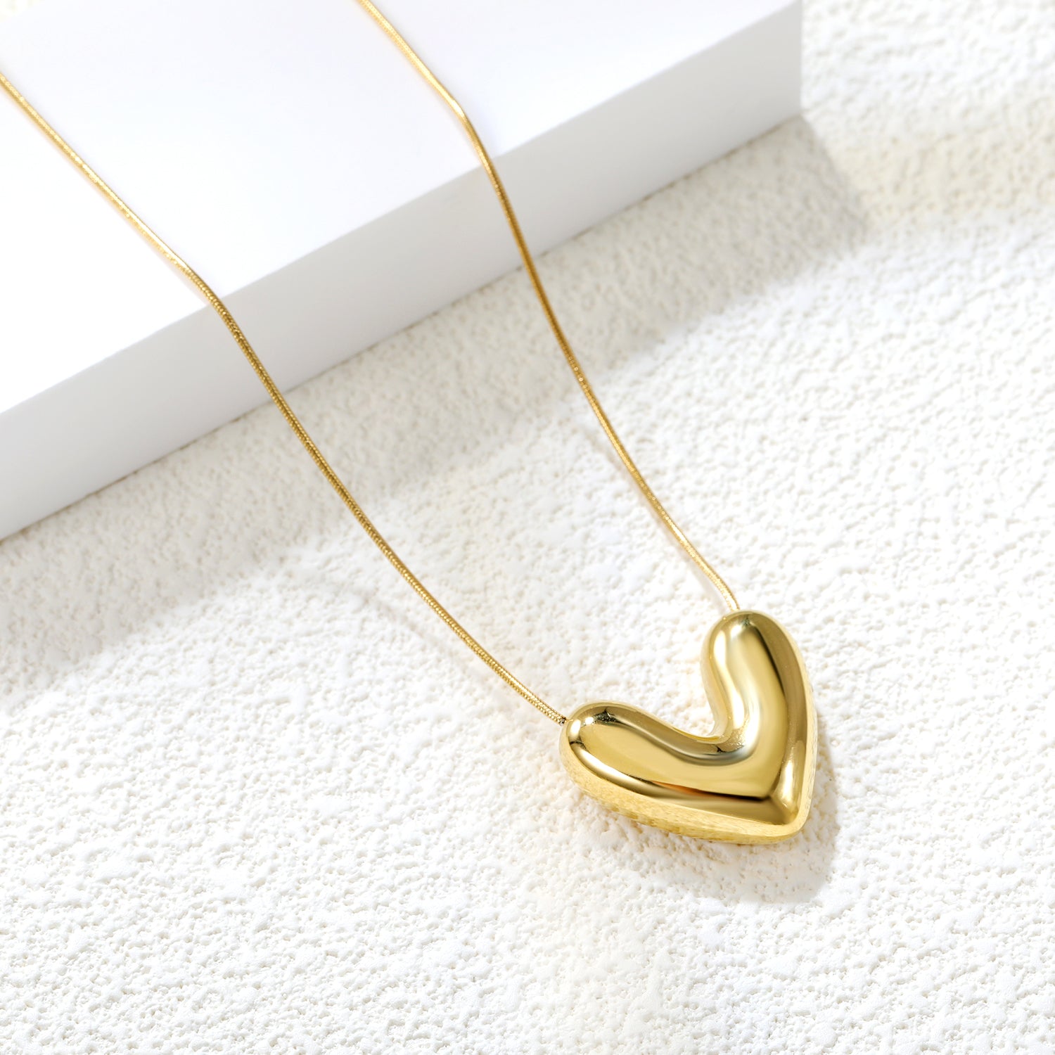 18k gold plated necklace with a heart-shaped pendant on a white 18K Gold Plated on premium Stainless Steel, this necklace  is 100% waterproof, sweat-proof, and anti-tarnish. Designed for active women. Skin-friendly for the Chennai gym heat. Buy 2 Get 1 FREE!background