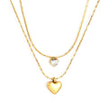 Two gold heart-shaped pendants on gold chains against a white background