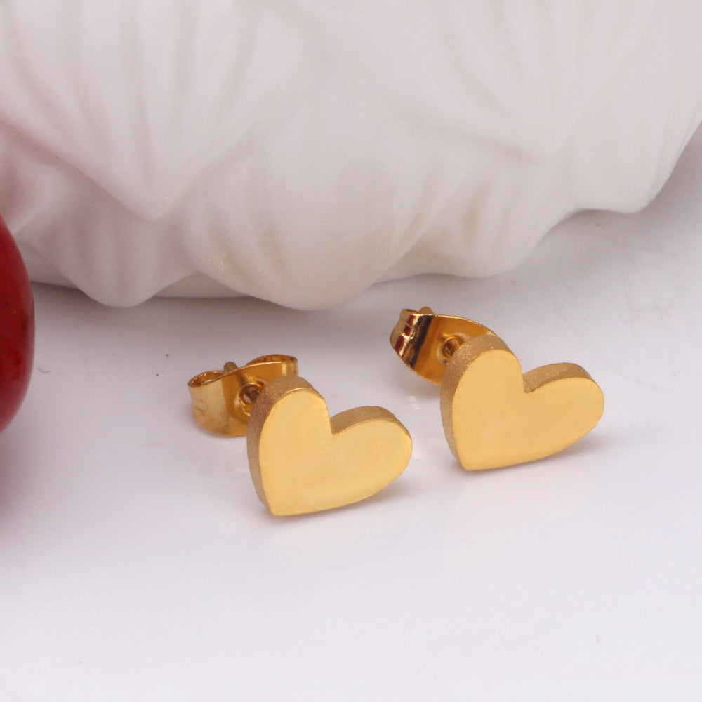 18k gold plated heart-shaped earrings on a white surface