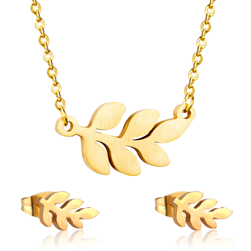 Gold leaf necklace and earrings set on a white background
