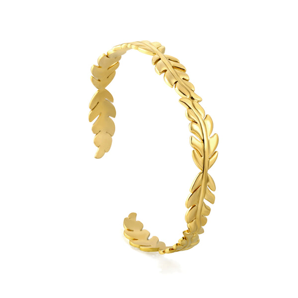 Gold leaf-patterned ring on a white background