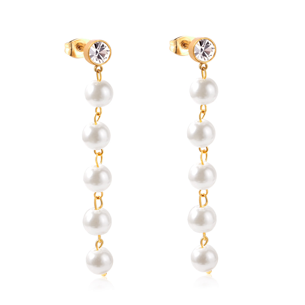 Pearl earrings with gold chains on a white background