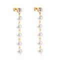 Pearl earrings with gold chains on a white background
