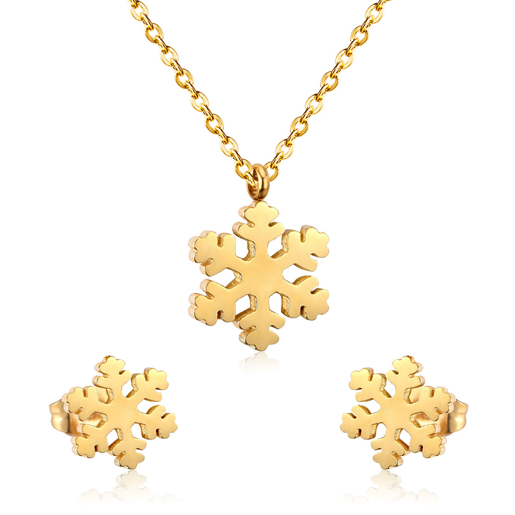 Gold snowflake necklace and earrings on a white background