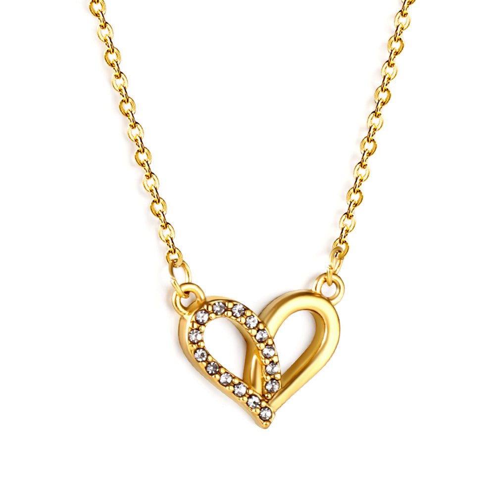 Gold heart-shaped necklace with embedded stones on a white background