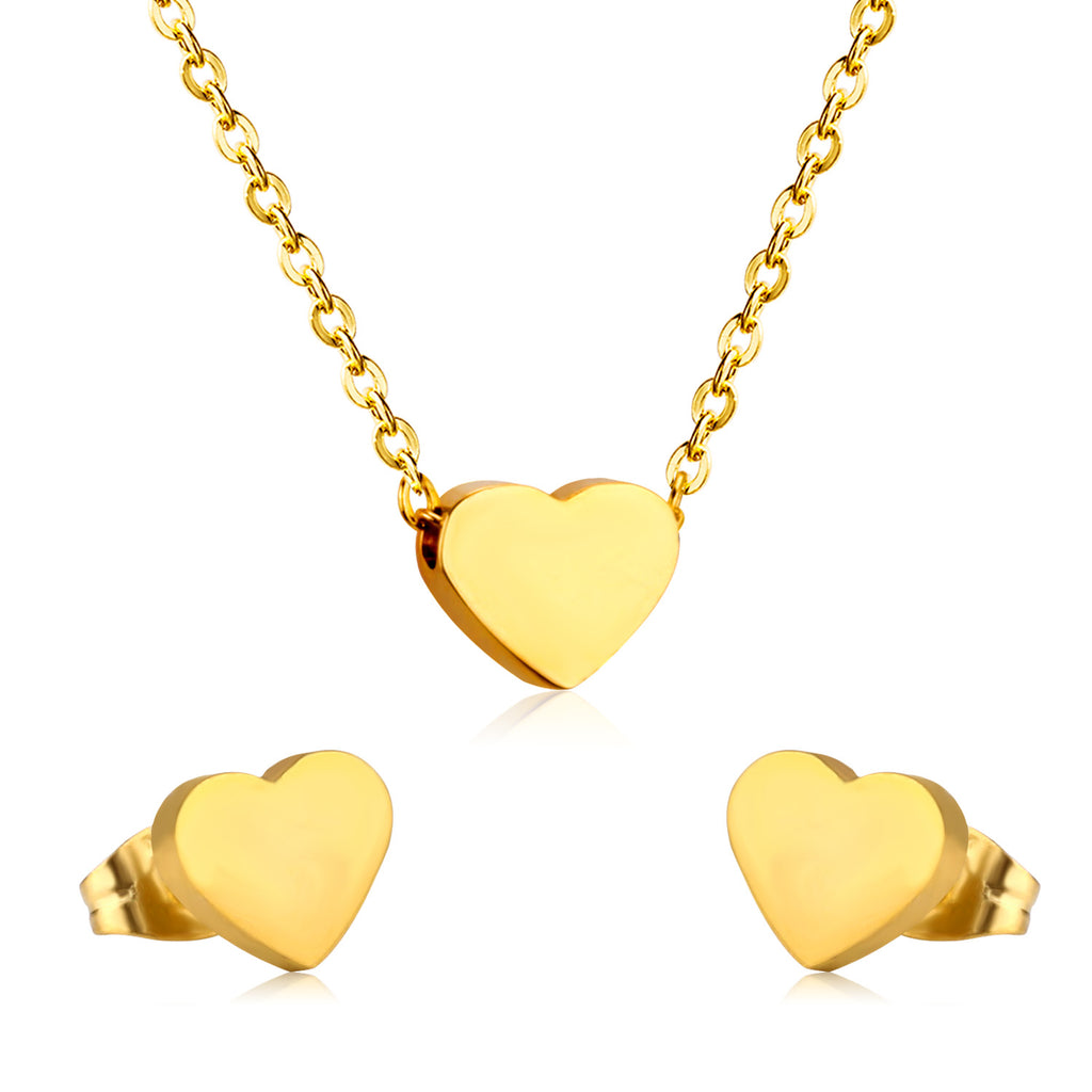 Gold heart-shaped necklace and earrings on a white background